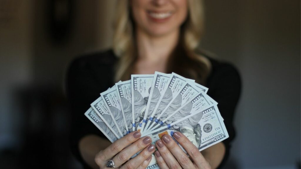 Make Money Online - Woman Holding Dollars