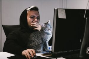 Man and Cat in front of TV Screen